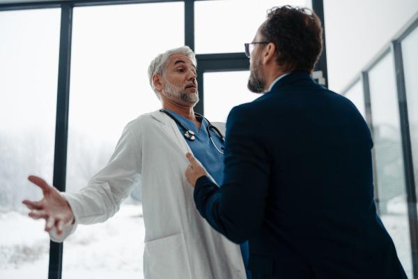 Aggressive Behavior A man being aggressive towards a doctor