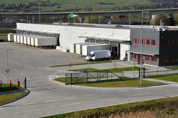 Logistics Hub Compliance A logistics hub and warehouse with a security gate