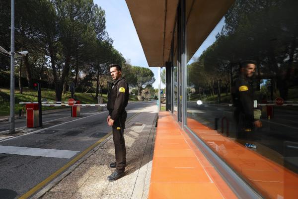 Logistics Access Control and Protection A Prosegur security guard at a security checkpoint blocking access for logistics trucks